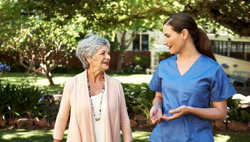 A person in scrubs talks to a patient