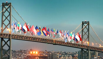 A bridge with a dozen country flags hanging from it