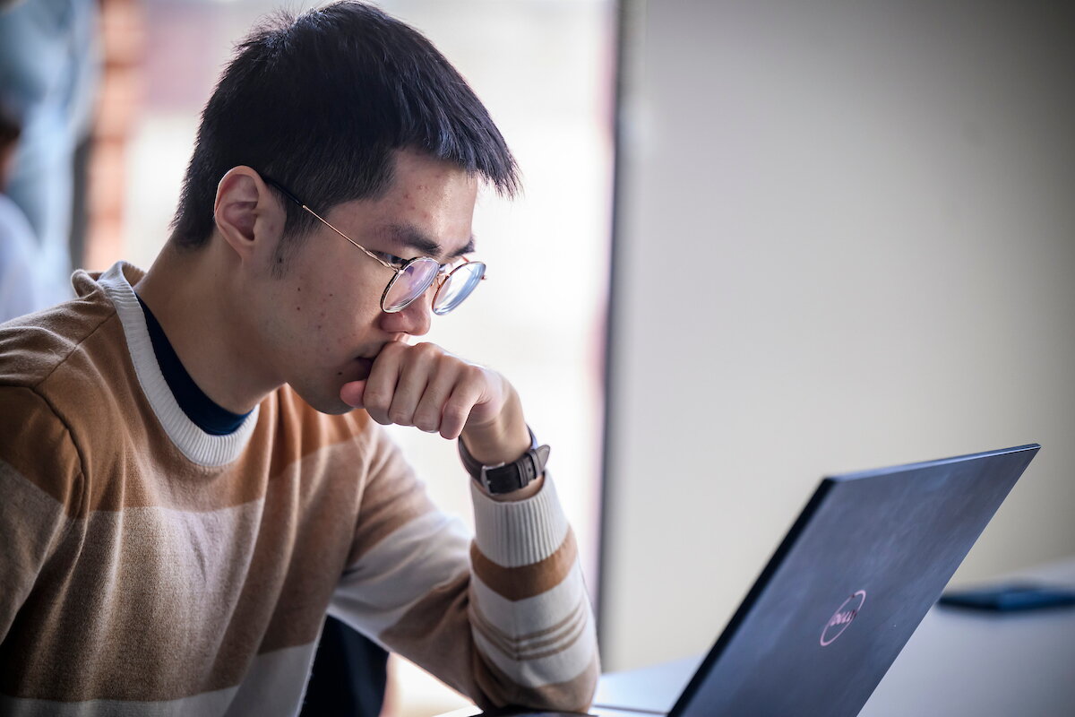 student in front of a laptop