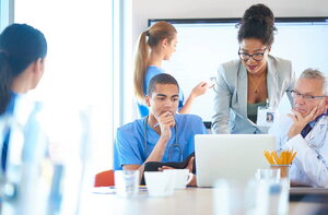 A doctor looks at a computer