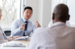 Employees chat during a meeting