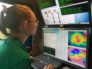 Atmos student in front of computers